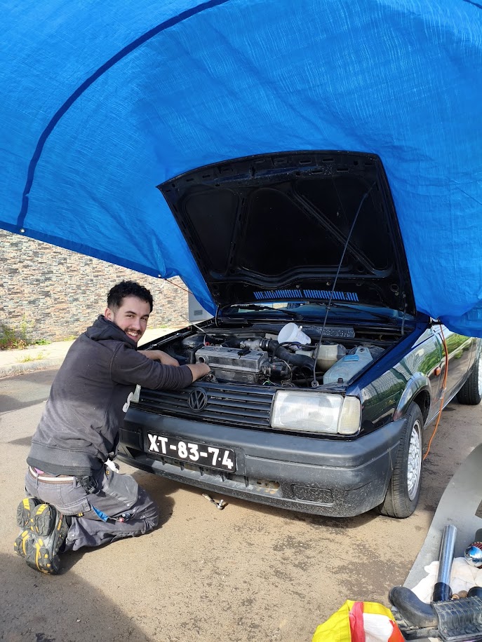 Car breakdown. The car is parked on the roadway with the hood open.
